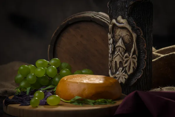Tambor, queso, una botella de vino y uvas — Foto de Stock