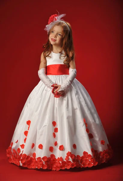 Little Girl White Dress Red Flower Petals Red Background — 图库照片