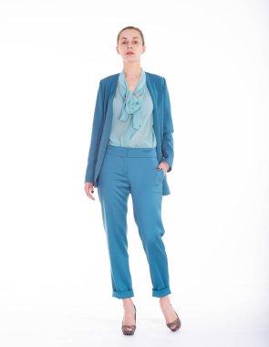 Young beautiful model in a business suit on a white background.