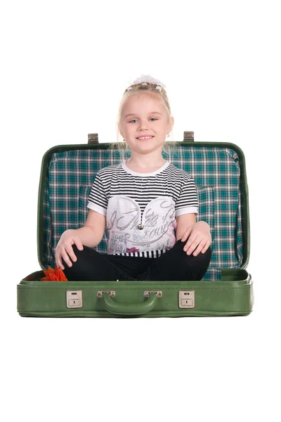 Child sitting in an old green suitcase in anticipation of travel — Stock Photo, Image