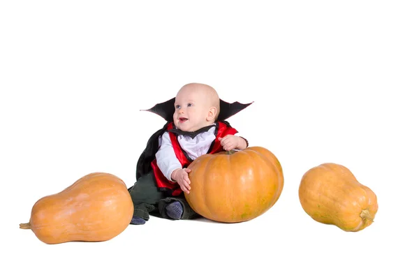 Baby boy in black halloween costume with pumpkins — Stock Photo, Image