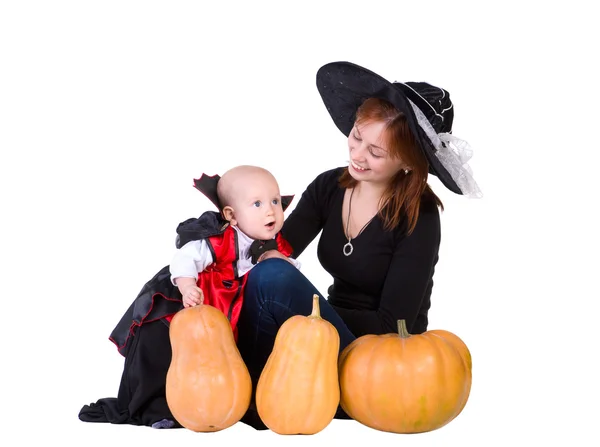 Baby boy and mother in black halloween cloak — Stock Photo, Image