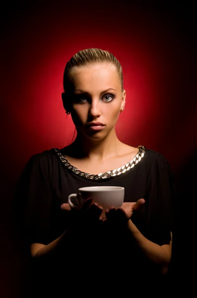 Sexy girl with aggressive makeup and white cup — Stock Photo, Image