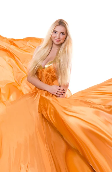 Blonde girl in orange flying dress — Stock Photo, Image