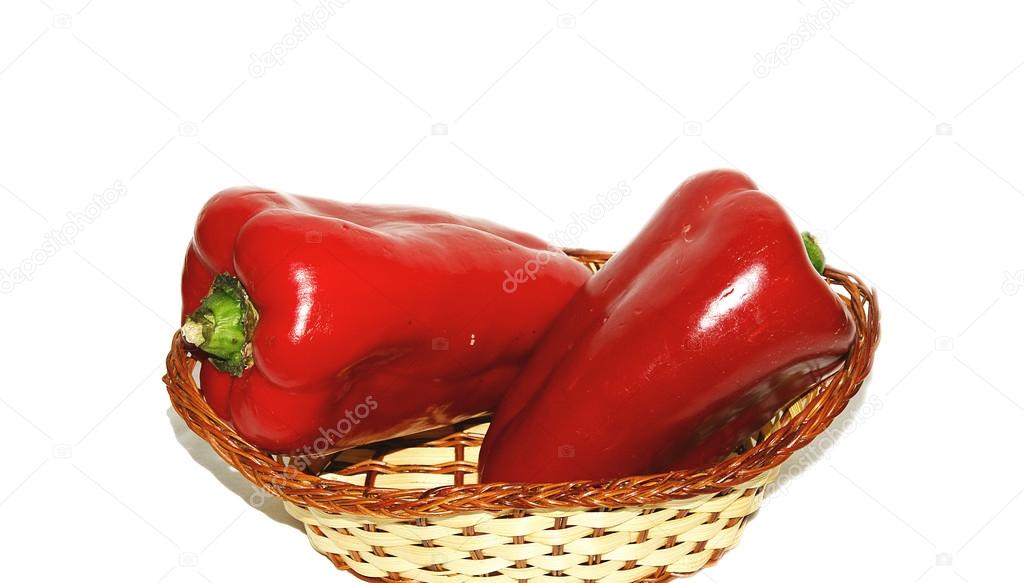 Basket of red peppers on white background