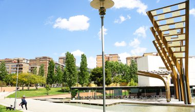 Gardens, pond and sculptures of wood and glass in Plaça de Ca N'Enseya