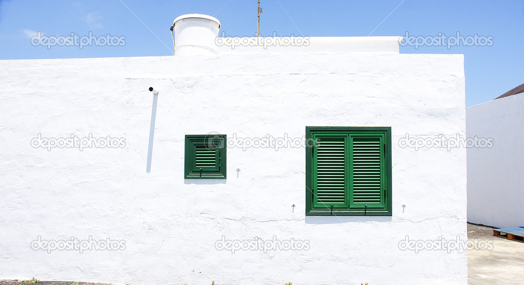 Architectural detail, door and window with green shutters for backgrounds and textures
