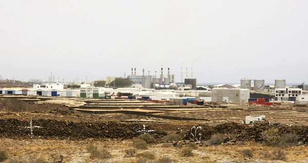 Rugged landscape with buildings and works — Stock Photo, Image