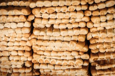 Rows of fresh bread in market. clipart