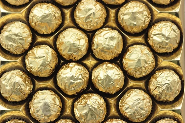 Chocolate sweets in golden foil — Stok Foto
