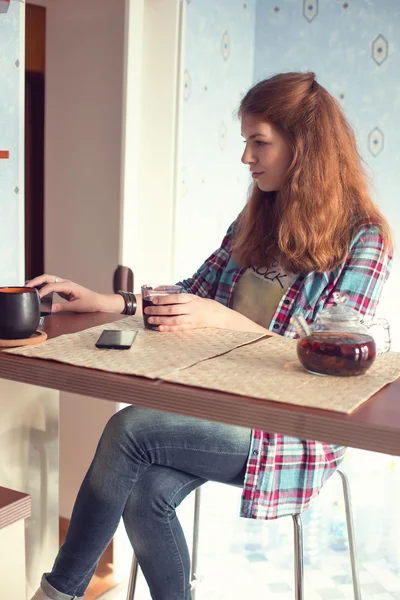 Lány italok tea a konyhában — Stock Fotó