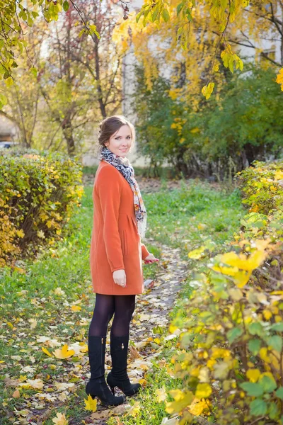 Girl in an orange coat — Stock Photo, Image