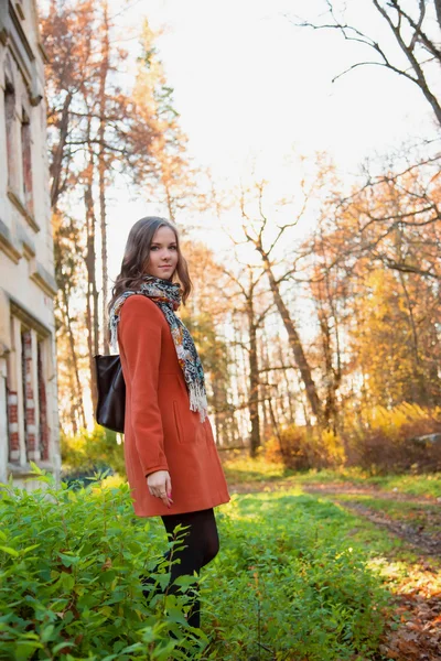 Girl in an orange coat — Stock Photo, Image