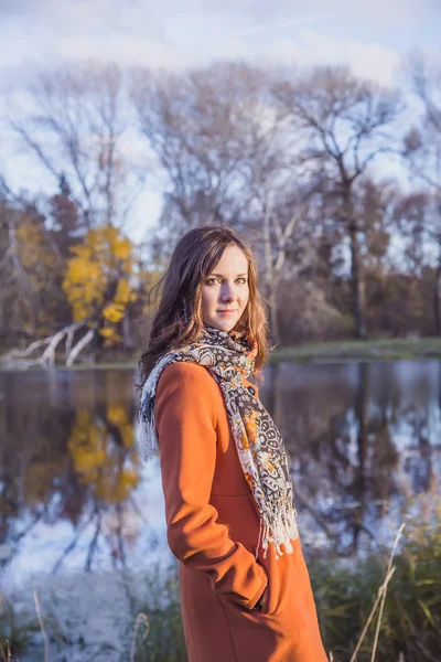 Girl in an orange coat — Stock Photo, Image