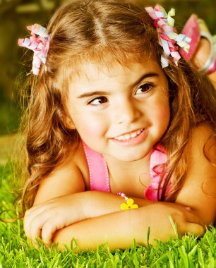 Little girl on green grass clipart