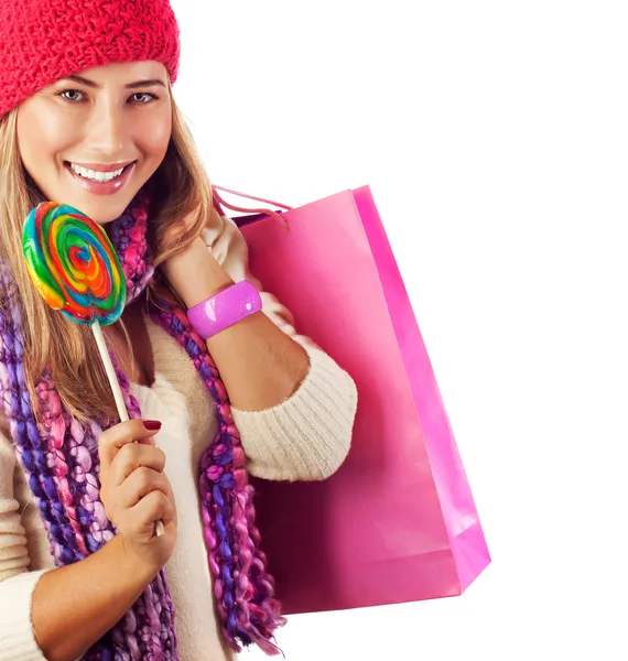 Pretty female with candy and paper bag — Stock Photo, Image