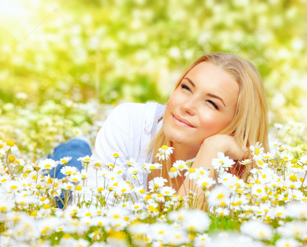 Woman in chamomile meadow
