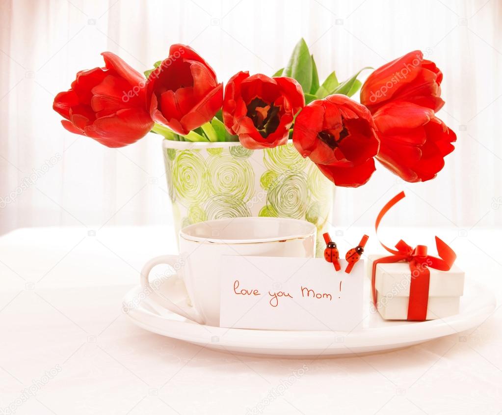 Red tulips and cup of tea