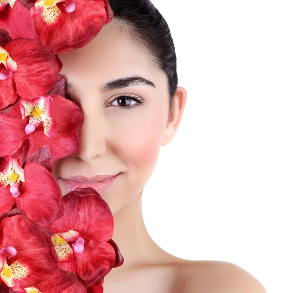 Vrouw met orchideebloemen op gezicht — Stockfoto