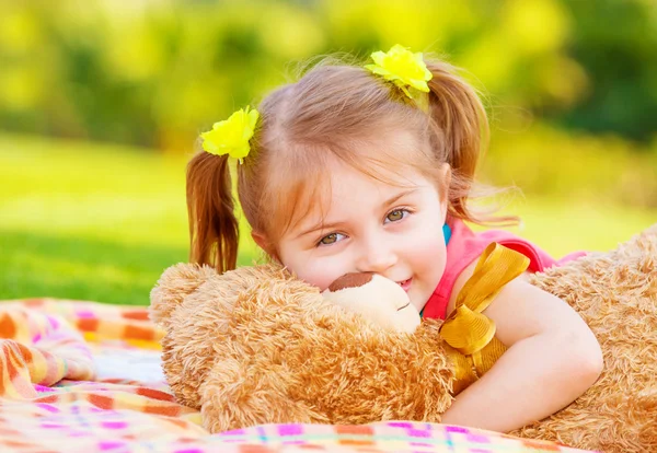 Little girl hugging soft toy — Stock Photo, Image