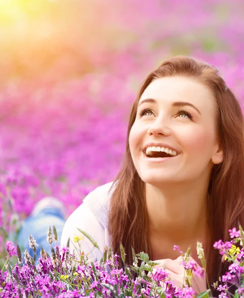 Schöne Frau auf Blumenfeld — Stockfoto