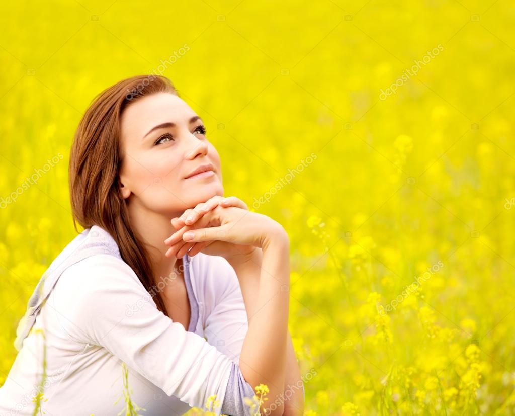 Cute female on yellow floral field