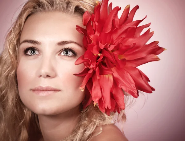 Blond girl with red flower — Stok fotoğraf