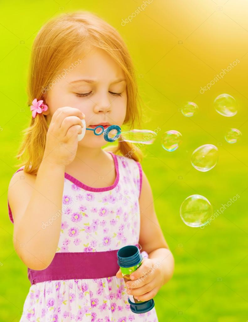 Baby girl blowing soap bubbles — Stock Photo © Anna_Om 26155135