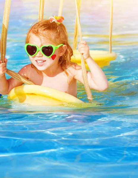 Little girl on water swing Stock Photo