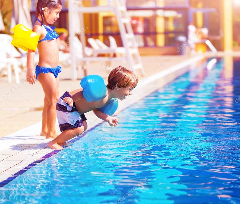 Little boy jumping into the pool