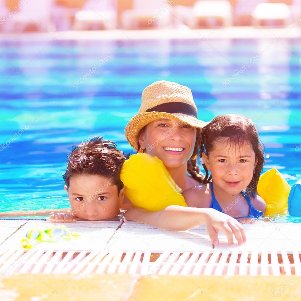 Mother with kids in poolside