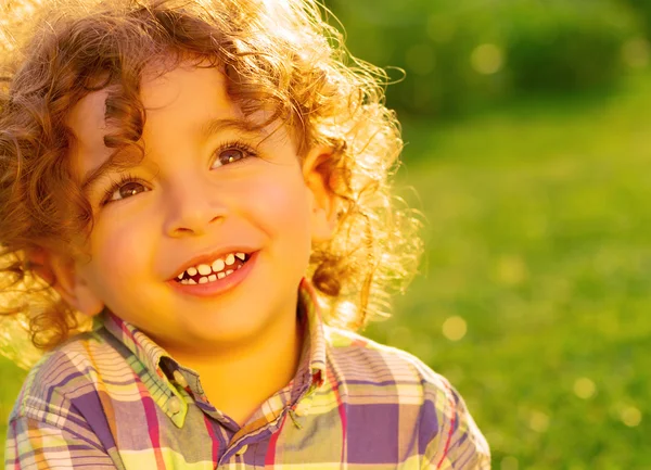 Happy little boy on green grass — Stock Photo, Image