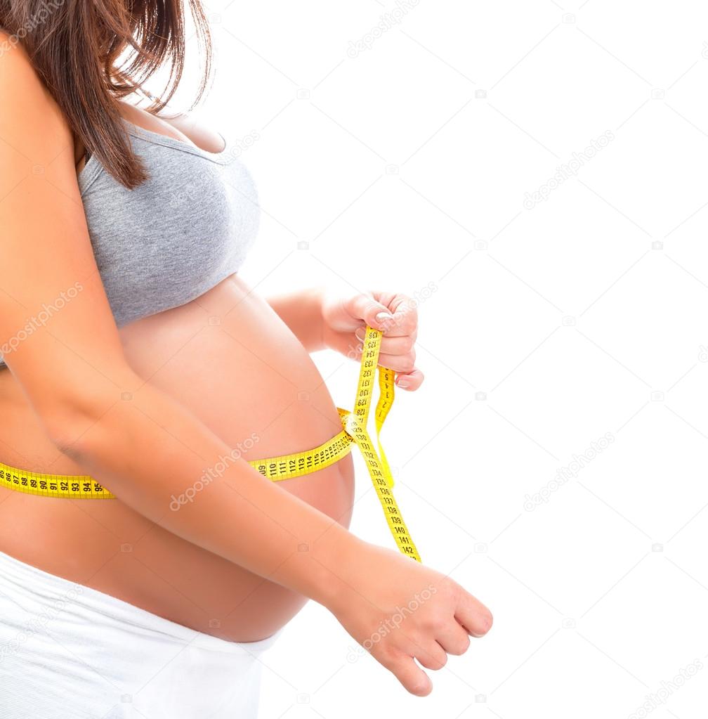 Pregnant girl measuring tummy