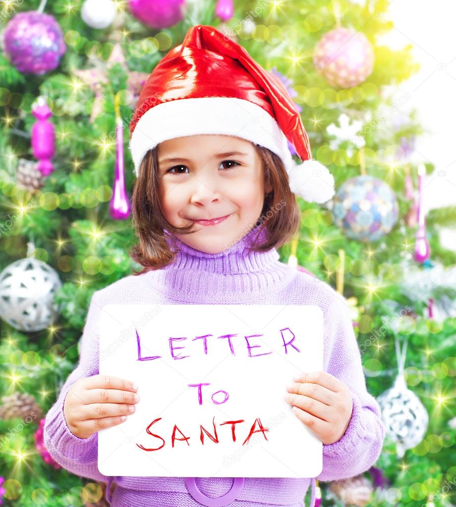 Little girl with letter to Santa Claus