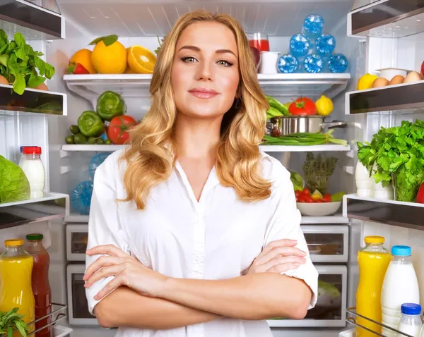 Healthy woman near open fridge — Stock Photo, Image