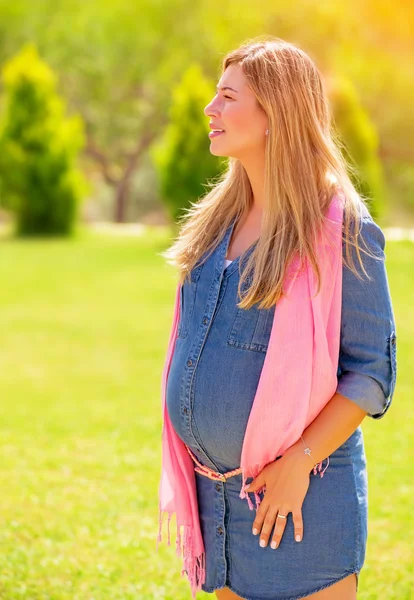 Pregnant woman outdoors Stock Picture