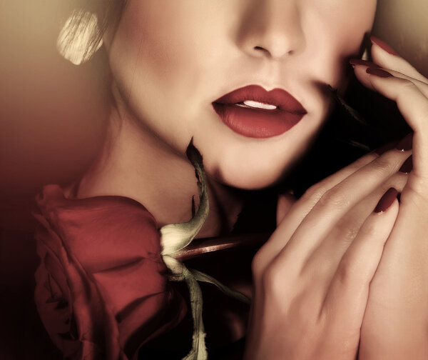 Closeup retro style photo of beautiful woman, half of face, sexy red lips and red rose in hands, passion and sensuality concept