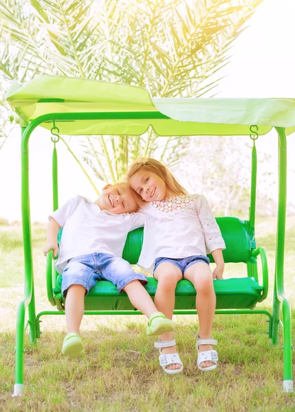 Gelukkige jonge geitjes op de schommel — Stockfoto