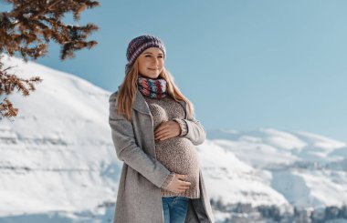 Happy Pregnant Woman Enjoying Winter clipart