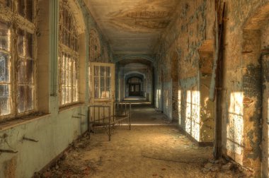 Abandoned hospital corridor with bed clipart