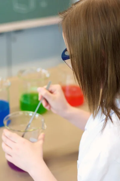 Ung kvinna experimentera i ett laboratorium — Stockfoto