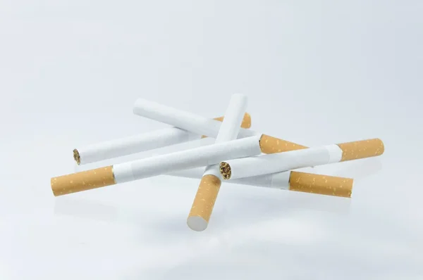 Cigarette et briquet sur fond blanc — Photo
