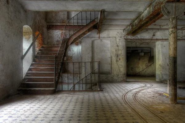 Old staircase in an abandoned hall Stock Photo