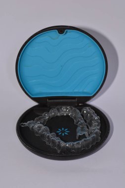 Milan,Italy - December 21,2021 : Align Technology Invisalign aligners in a case, Invisalign are plastic clear aligners,know as invisible orthodontics,customized to fit jaw used for bite correction.