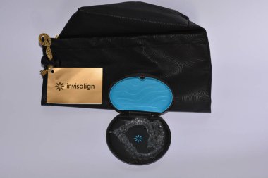 Milan,Italy - December 21,2021 : Align Technology Invisalign aligners in a case, Invisalign are plastic clear aligners,know as invisible orthodontics,customized to fit jaw used for bite correction.