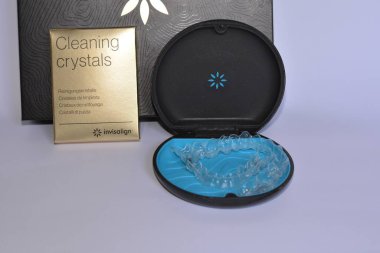 Milan,Italy - December 21,2021 : Align Technology Invisalign aligners in a case, Invisalign are plastic clear aligners,know as invisible orthodontics,customized to fit jaw used for bite correction.