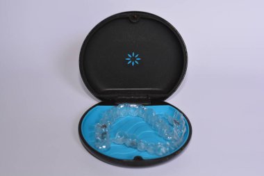 Milan,Italy - December 21,2021 : Align Technology Invisalign aligners in a case, Invisalign are plastic clear aligners,know as invisible orthodontics,customized to fit jaw used for bite correction.