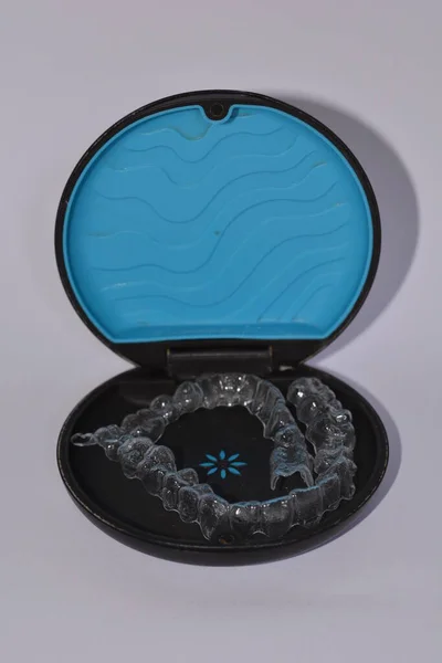 Milan,Italy - December 21,2021 : Align Technology Invisalign aligners in a case, Invisalign are plastic clear aligners,know as invisible orthodontics,customized to fit jaw used for bite correction.