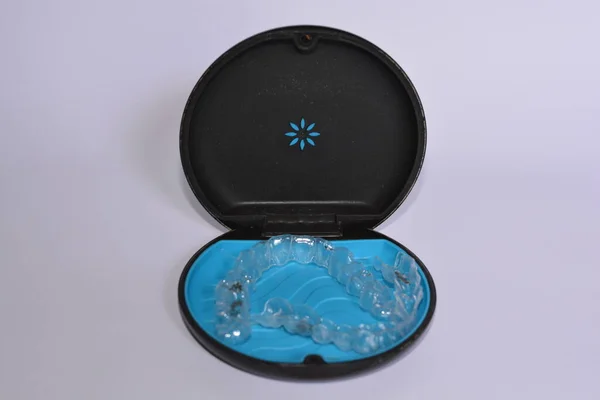 Milan,Italy - December 21,2021 : Align Technology Invisalign aligners in a case, Invisalign are plastic clear aligners,know as invisible orthodontics,customized to fit jaw used for bite correction.