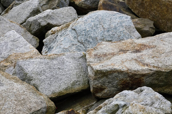 Pile of large boulders protecting coast from the destructive effects of large waves during stormy weather